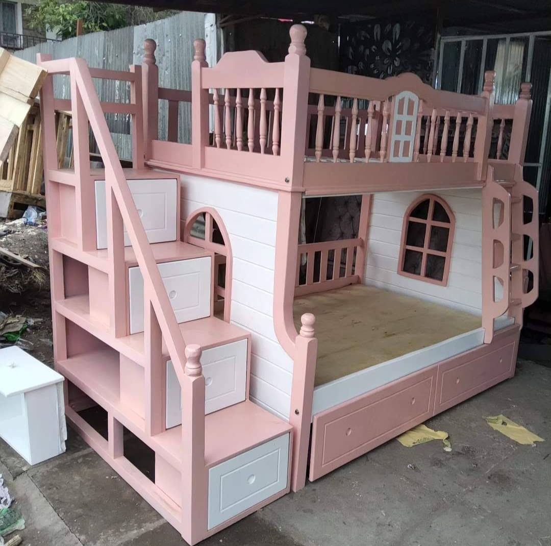 Pink and white kids' house bunk bed with staircase drawers