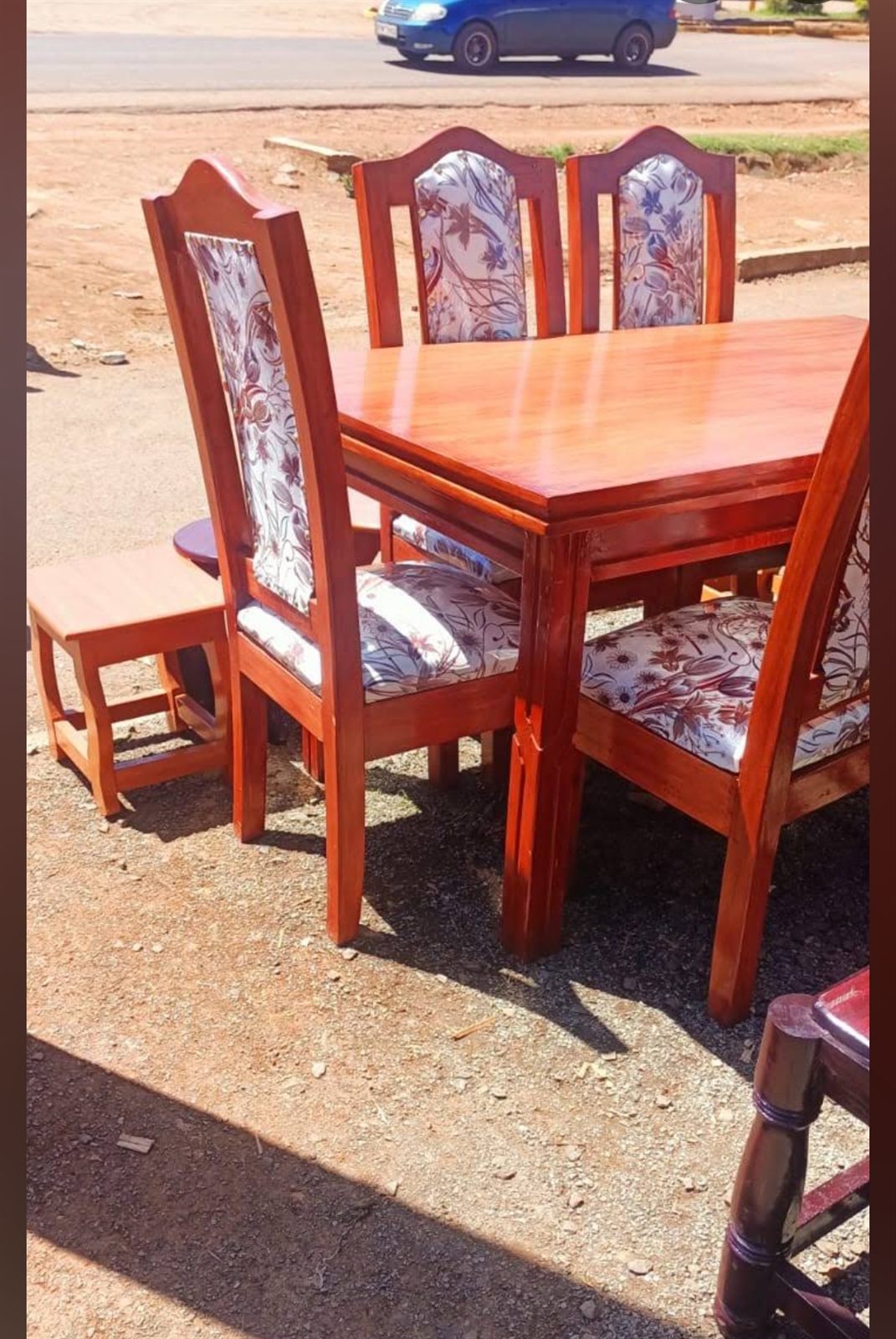 Glossy mahogany six-seater dining table with floral upholstered chairs